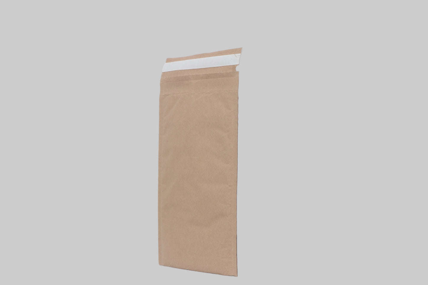 Brown paper bag on a white surface with a white background